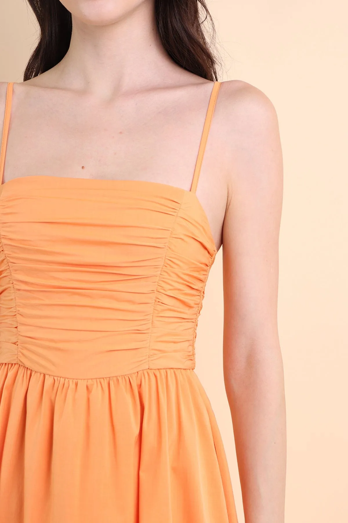 LOLA SLEEVELESS RUCHED ROMPER DRESS IN ORANGE